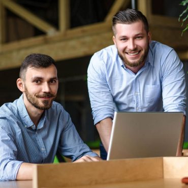 picture-handsome-businessman-listening-his-colleague-partner-concerning-ner-business-system-while-working-laptop-computer-office-interior picture-handsome-businessman-listening-his-colleague-partner-concerning-ner-business-system-while-working-laptop-computer-office-interior